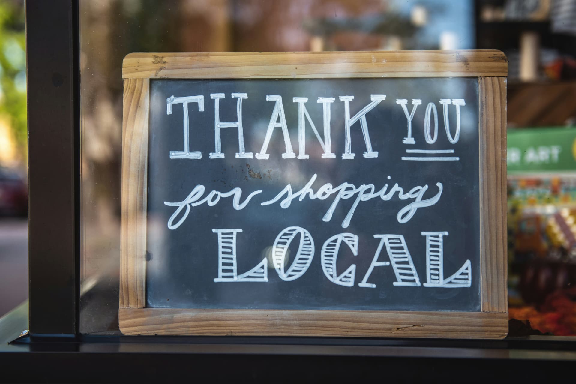 Chalkboard sign reading Thank You for shopping local